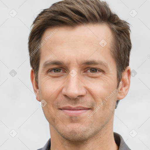 Joyful white adult male with short  brown hair and brown eyes