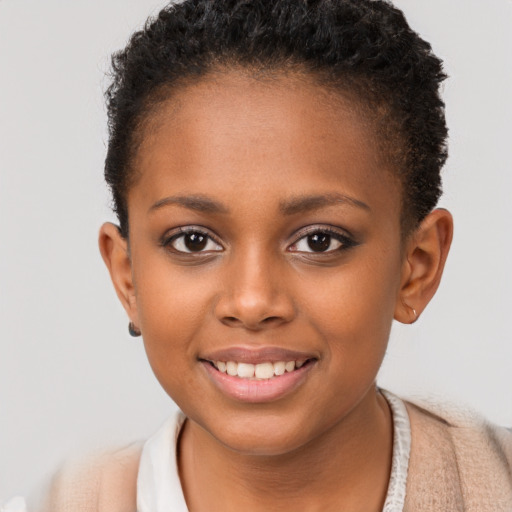 Joyful black child female with short  brown hair and brown eyes
