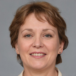 Joyful white adult female with medium  brown hair and grey eyes