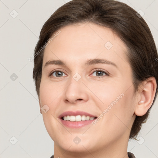 Joyful white young-adult female with medium  brown hair and brown eyes