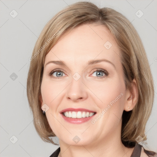 Joyful white adult female with medium  brown hair and blue eyes