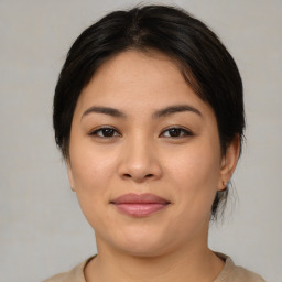 Joyful asian young-adult female with medium  brown hair and brown eyes