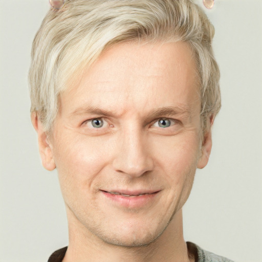 Joyful white adult male with short  blond hair and grey eyes