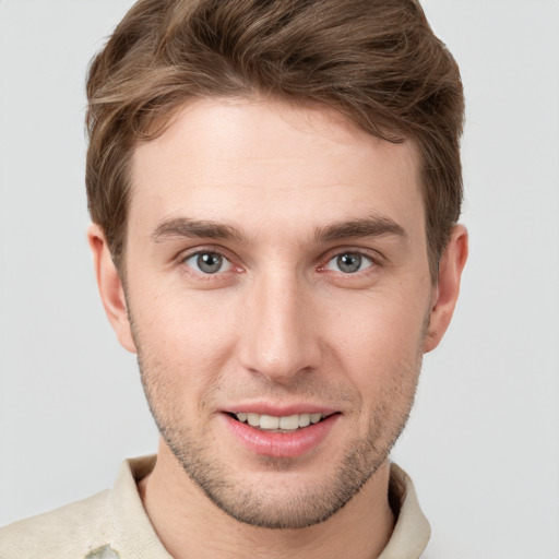 Joyful white young-adult male with short  brown hair and grey eyes