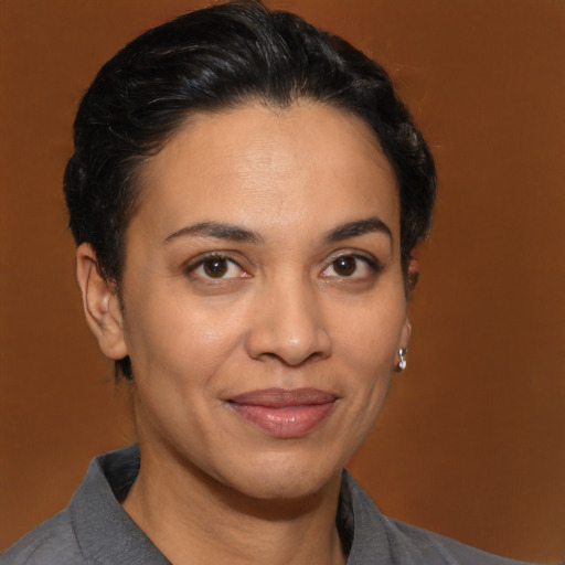 Joyful latino young-adult female with short  brown hair and brown eyes