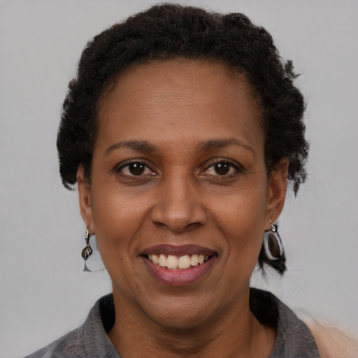 Joyful black adult female with short  brown hair and brown eyes