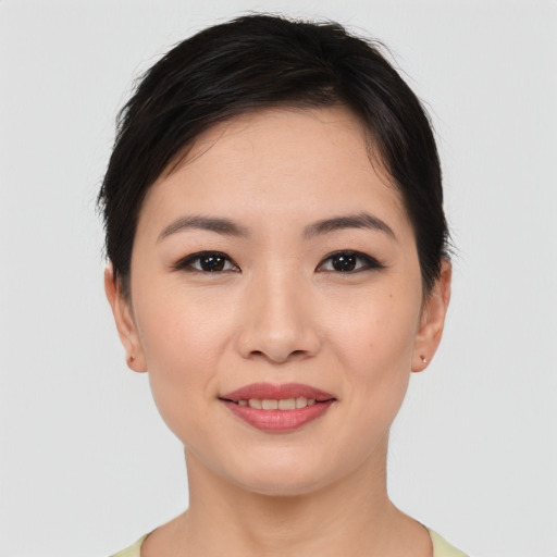 Joyful asian young-adult female with short  brown hair and brown eyes