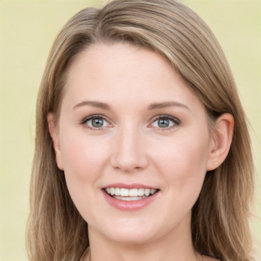 Joyful white young-adult female with long  brown hair and blue eyes