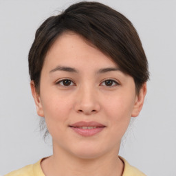 Joyful asian young-adult female with short  brown hair and brown eyes