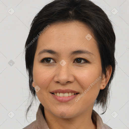 Joyful asian adult female with medium  brown hair and brown eyes