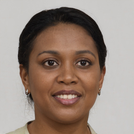 Joyful black young-adult female with short  brown hair and brown eyes