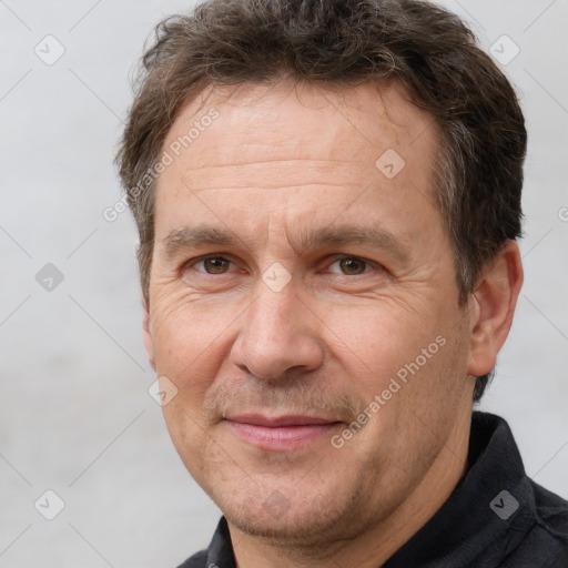 Joyful white adult male with short  brown hair and brown eyes