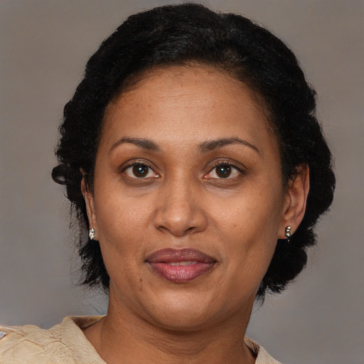 Joyful latino adult female with short  black hair and brown eyes