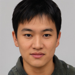 Joyful asian young-adult male with short  black hair and brown eyes