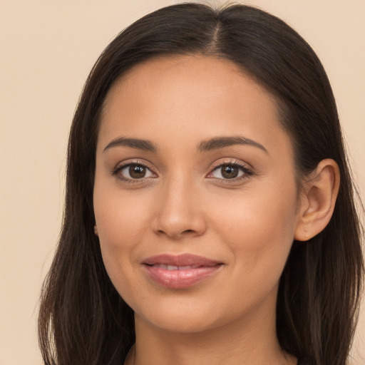 Joyful latino young-adult female with long  brown hair and brown eyes