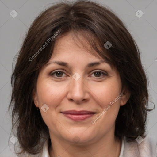 Joyful white adult female with medium  brown hair and brown eyes