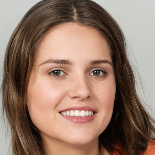 Joyful white young-adult female with long  brown hair and green eyes