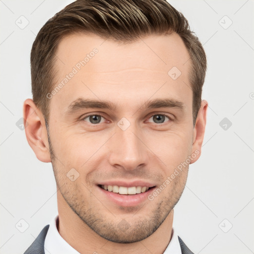 Joyful white young-adult male with short  brown hair and grey eyes