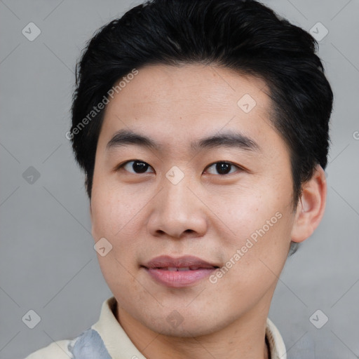 Joyful asian young-adult male with short  black hair and brown eyes