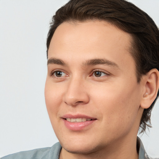 Joyful white young-adult male with medium  brown hair and brown eyes