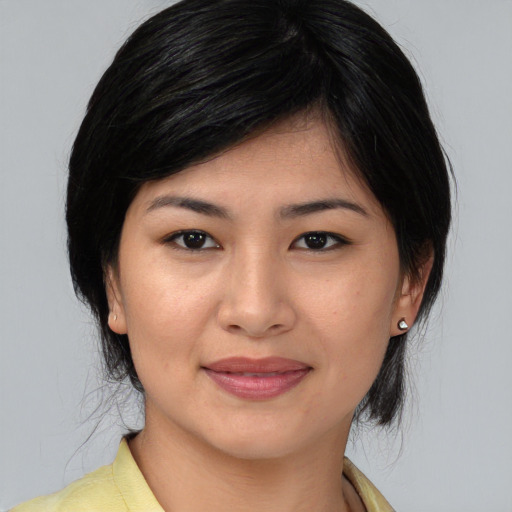 Joyful asian young-adult female with medium  black hair and brown eyes