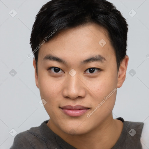 Joyful asian young-adult male with short  black hair and brown eyes