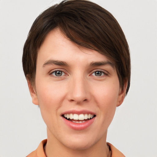 Joyful white young-adult female with short  brown hair and grey eyes