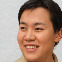 Joyful asian young-adult female with short  brown hair and brown eyes