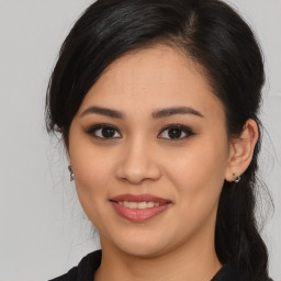 Joyful white young-adult female with long  brown hair and brown eyes