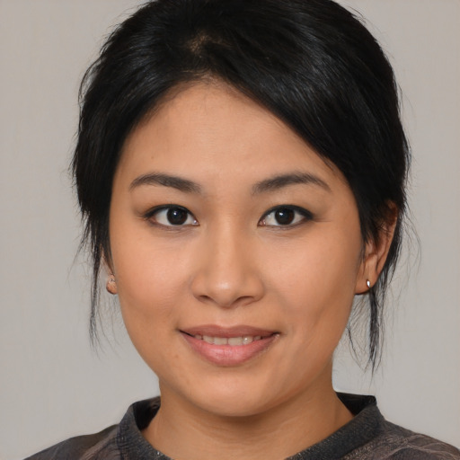 Joyful asian young-adult female with medium  black hair and brown eyes