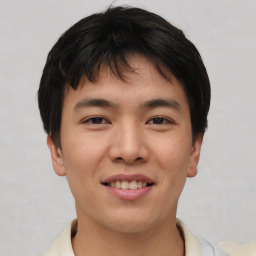 Joyful asian young-adult male with short  brown hair and brown eyes