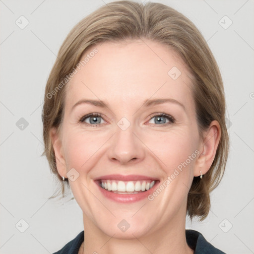 Joyful white adult female with medium  brown hair and grey eyes