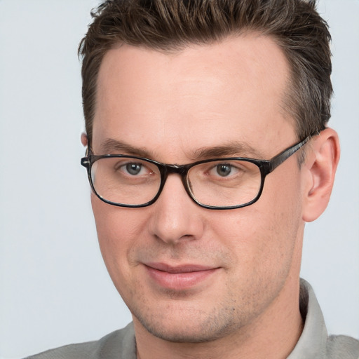 Joyful white adult male with short  brown hair and brown eyes