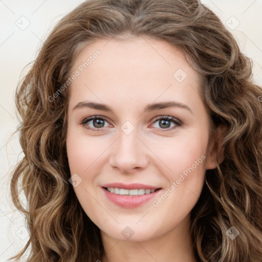 Joyful white young-adult female with long  brown hair and green eyes