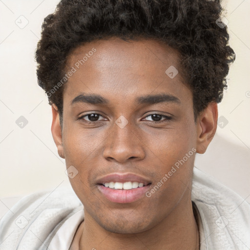 Joyful black young-adult male with short  brown hair and brown eyes