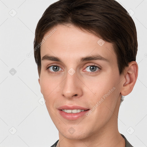 Joyful white young-adult female with short  brown hair and grey eyes