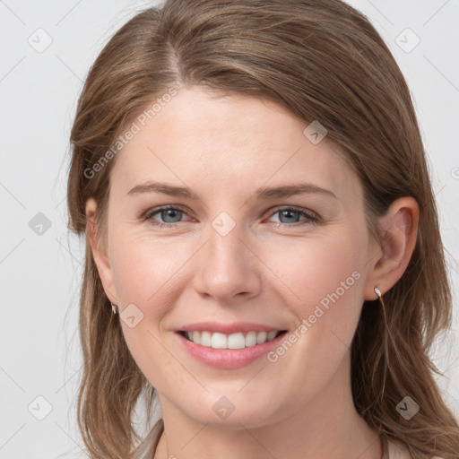 Joyful white young-adult female with long  brown hair and blue eyes