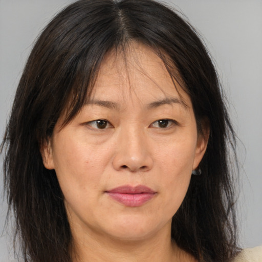 Joyful asian adult female with medium  brown hair and brown eyes