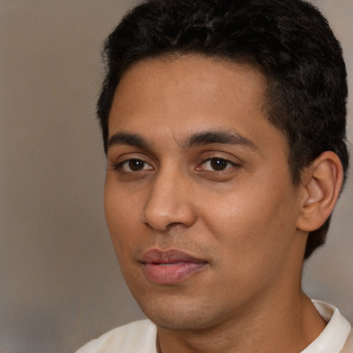 Joyful latino young-adult male with short  black hair and brown eyes