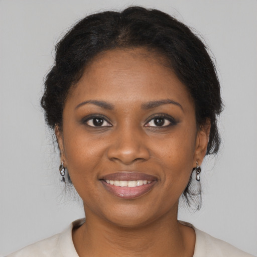 Joyful black young-adult female with medium  brown hair and brown eyes