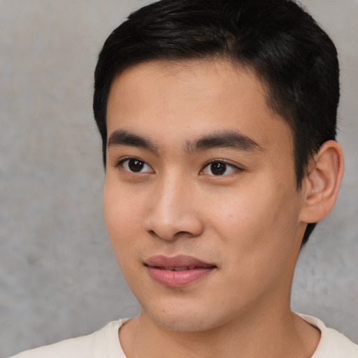 Joyful asian young-adult male with short  black hair and brown eyes
