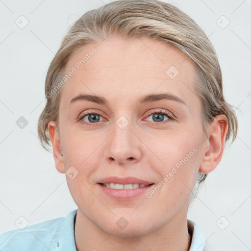 Joyful white young-adult female with medium  brown hair and blue eyes