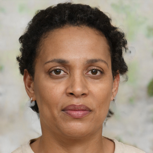 Joyful black adult female with short  brown hair and brown eyes