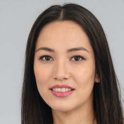 Joyful asian young-adult female with long  brown hair and brown eyes