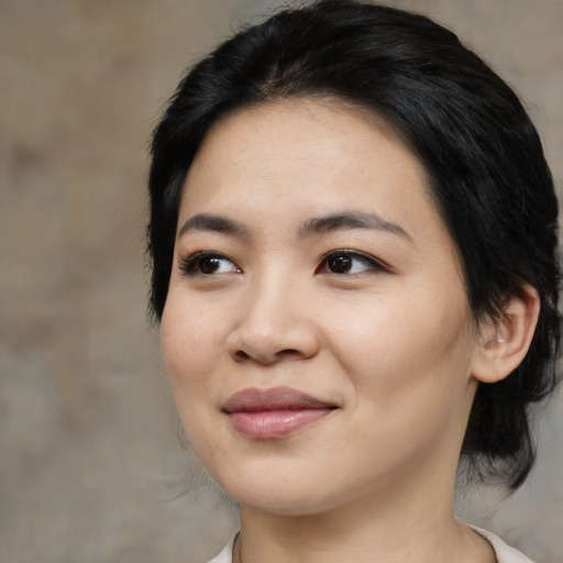 Joyful asian young-adult female with medium  black hair and brown eyes