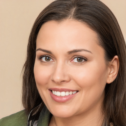 Joyful white young-adult female with long  brown hair and brown eyes