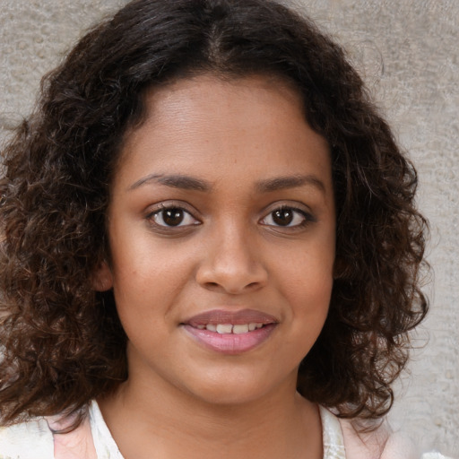 Joyful black young-adult female with medium  brown hair and brown eyes