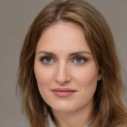 Joyful white young-adult female with medium  brown hair and green eyes