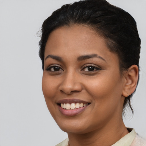 Joyful latino young-adult female with short  brown hair and brown eyes