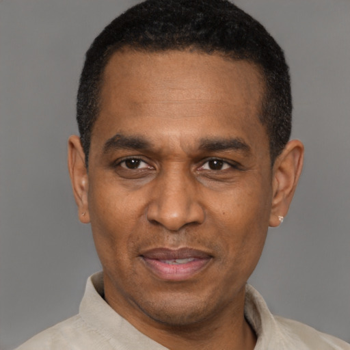 Joyful latino adult male with short  black hair and brown eyes